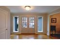 Inviting foyer features hardwood floors, a double-door entry, and sidelight windows for natural light at 1104 Fox Ln, Woodstock, GA 30188