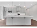 Spacious kitchen featuring a central island with light countertops and ample cabinetry with modern lighting fixtures at 1261 Burlington Ct, Mcdonough, GA 30253
