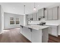 Bright kitchen with stainless steel appliances, gray cabinets, a large island, and a separate dining area filled with natural light at 1261 Burlington Ct, Mcdonough, GA 30253