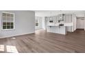 Open-concept living room and kitchen with lots of natural light and hardwood floors for modern living at 1261 Burlington Ct, Mcdonough, GA 30253