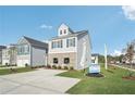 Two-story home featuring gray siding, brick accents, and a spacious driveway at 2015 Wyndham Pl, Conyers, GA 30013