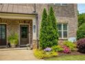 Close-up of the front porch with a well-manicured garden and a brick facade at 1365 Hawthorne Se Ave, Smyrna, GA 30080