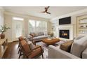 Inviting living room featuring a fireplace, built-in shelves, neutral decor, and large windows at 1365 Hawthorne Se Ave, Smyrna, GA 30080