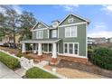 Charming two-story home with a covered front porch, white picket fence, and well-maintained landscaping at 174 Kelly St, Norcross, GA 30071