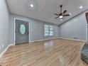 Open living room features hardwood floors, a stylish front door, recessed lighting, and ceiling fan at 4422 Fincher Rd, Canton, GA 30114