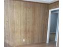 This living room features paneled walls and beautiful laminate floors at 5278 Madison St, Forest Park, GA 30297