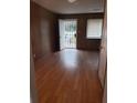 Bright living room with wood-paneled walls and laminate flooring throughout at 5278 Madison St, Forest Park, GA 30297