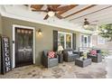 Inviting front porch with comfortable seating, ceiling fans, stone flooring and 'Welcome' sign at 167 Freyer Ne Dr, Marietta, GA 30060
