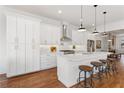 Modern kitchen featuring white cabinetry, stainless steel appliances, hardwood floors and a spacious island with seating at 971 Boulevard Se # A, Atlanta, GA 30312