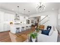 Bright open living space with modern lighting, hardwood floors, and a spacious open floor plan to the kitchen at 971 Boulevard Se # A, Atlanta, GA 30312
