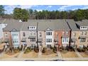 Aerial shot of townhouses showing the roofline and landscaping in a suburban neighborhood at 2569 Village Park Bnd, Duluth, GA 30096