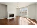 Bright living room with hardwood floors, fireplace, and large windows at 2569 Village Park Bnd, Duluth, GA 30096