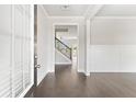 Inviting entryway with gleaming hardwood floors and view of staircase at 3787 Lockaby Way, Lawrenceville, GA 30044