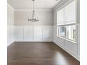 Light-filled living room boasts hardwood floors, large windows and classic white trim at 3787 Lockaby Way, Lawrenceville, GA 30044