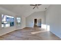 This spacious room features large windows for natural light and beautiful new floors throughout at 2822 Ward Lake Way, Ellenwood, GA 30294