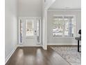 Bright foyer with hardwood floors, front door with sidelights, and a view to the outside at 3897 Lockaby Way, Lawrenceville, GA 30044