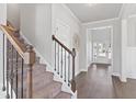 Carpeted staircase with stained wood and iron railings, leading to the upper level of the home at 3897 Lockaby Way, Lawrenceville, GA 30044