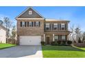 Charming two-story home featuring a brick and siding facade and manicured lawn at 238 Gallant Fox Way, Acworth, GA 30102