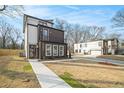 Modern home exterior showcasing clean lines and a well-maintained lawn and driveway at 662 S Grand Nw Ave, Atlanta, GA 30318