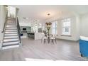 Open-concept living space with hardwood floors, leading to a modern kitchen with stainless steel appliances at 662 S Grand Nw Ave, Atlanta, GA 30318