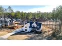 Aerial view of a modern farmhouse showcasing its roofline, landscaping, and large lot at 71 Presley Farm Ln, Rockmart, GA 30153