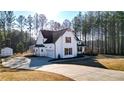 Charming home with a wide driveway leading to an attached garage and a separate storage shed at 71 Presley Farm Ln, Rockmart, GA 30153