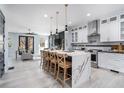 Gourmet kitchen with a waterfall island, stainless steel appliances, and modern pendant lighting at 676 S Grand Nw Ave, Atlanta, GA 30318