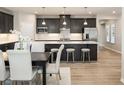 Open-concept kitchen and dining area with stainless steel appliances and large central island at 1141 Burlington Ct, Mcdonough, GA 30253