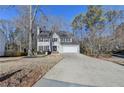 Charming two-story home featuring a two-car garage, double front door, and black window shutters at 711 Providence Dr, Lawrenceville, GA 30044