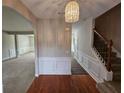 Elegant foyer featuring hardwood floors, a staircase, and a decorative chandelier at 7214 Bedrock Cir, Lithonia, GA 30038