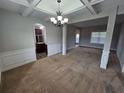 Inviting living room with tray ceilings, columns, and ample natural light at 7214 Bedrock Cir, Lithonia, GA 30038