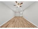 Empty living room showcasing wood floors, neutral paint and ceiling fan at 1179 Church St # J, Decatur, GA 30030