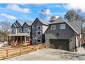 Charming two-story home featuring a covered porch, fenced yard, and attached garage at 4115 Merritt Dr, Cumming, GA 30041