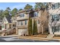 Charming two-story home showcasing its exterior details, including a garage, front porch, and professionally landscaped surroundings at 10 Clarke Hill St, Decatur, GA 30030