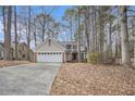 Charming two-story home with brick accents and a two-car garage nestled amongst mature trees at 3214 Country Walk Dr, Powder Springs, GA 30127