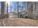 Charming two-story home with brick accents and a two-car garage nestled amongst mature trees at 3214 Country Walk Dr, Powder Springs, GA 30127