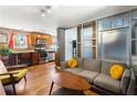 Stylish living room featuring a gray sofa, glass divider and brick accent wall at 562 Formwalt Sw St # 5, Atlanta, GA 30312