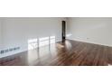 Well-lit living room showcasing gleaming hardwood floors and neutral paint, creating a warm atmosphere at 1722 Detroit Nw Ave, Atlanta, GA 30314