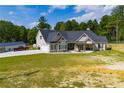 Beautiful single-story home with front porch, garage, additional building and spacious lawn at 1291 Pleasant Grove Church Rd, Villa Rica, GA 30180