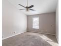 Bedroom with a ceiling fan, neutral carpet, and natural light streaming through the window at 5876 Old Wellborn Trce, Lithonia, GA 30058
