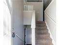 Bright foyer featuring staircase with neutral carpet and white banister and railings at 5876 Old Wellborn Trce, Lithonia, GA 30058