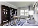 Stylish home office features custom built-in shelving, a large window, and modern decor at 1148 Burlington Ct, Mcdonough, GA 30253