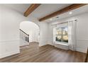 Cozy living room with hardwood floors, large window, and stairway at 1323 Champion Run Dr, Dacula, GA 30019