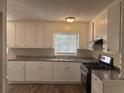 Bright kitchen featuring white cabinets, modern appliances, and durable countertops at 3900 Boulder Park Sw Dr, Atlanta, GA 30331