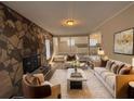 Comfortable living room featuring a stone accent wall, plush seating, and modern decor at 3900 Boulder Park Sw Dr, Atlanta, GA 30331