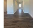 Inviting hallway featuring wood-look floors, crisp white trim, and a view of the front door at 822 Kestrel Dr, Loganville, GA 30052