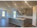 Modern kitchen boasts an island, granite countertops, stainless appliances, and ample storage space at 822 Kestrel Dr, Loganville, GA 30052