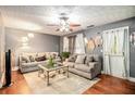 Cozy living room with hardwood floors, ceiling fan, and comfortable seating at 338 Saratoga Pl, Riverdale, GA 30296
