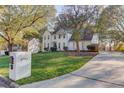 A lovely two-story home with a manicured lawn, mature trees, and a driveway at 3782 Brookside Pkwy, Decatur, GA 30034