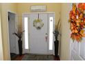 Warm and inviting foyer with decorative accents, a bright front door and wood floors at 5627 Isleworth Ct, Atlanta, GA 30349